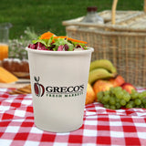 32 oz paper food container, with "Greco's" logo with an apple illustration, filled with garden salad, on a picnic blanket