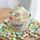 5 oz paper food container with the "District Ice Cream" logo, filled with ice cream and toppings, on wooden table