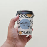 8 oz. Full Wrap Recyclable Paper Cup displaying "Coffee House", held in front of a white background.