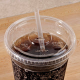Clear compostable plastic flat straw lid with "greenware" text on plastic cup with cola inside and straw, on wooden table
