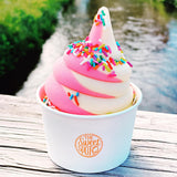 8 oz paper food container, with orange logo "The Sweet Spot", filled with pink and white ice cream, on a picnic table