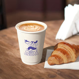 12 oz double walled paper cup, with a blue logo "Coffee & Croissant" and illustration of a girl, filled with coffee with foam, standing on a wooden table next to a croissant