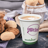 8 oz paper cup with green stripe and "ecotainer" text, printed "Coffee Line" logo in purple, filled with coffee, on black table with cookies