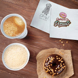 Two 3-PLY White Beverage Napkin of different logos lying slightly apart, beside two hot takeout coffee cups and a donut on wax paper. 