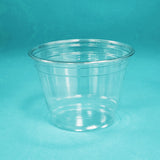Blank 9 oz plastic cup standing on blue background